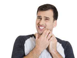 A man suffering from a tooth ache he may be a candidate for a root canal.