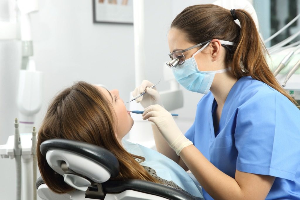 dentist examining a patient teeth picture id810206880 1024x682 1