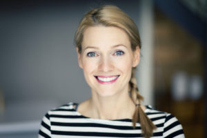 Smiling blond woman wearing a striped shirt