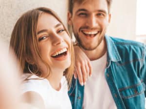 Smiling beautiful girl and her handsome boyfriend taking selfie 300x225 1