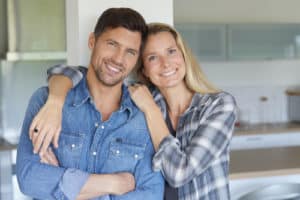 Portrait of cheerful middle aged couple at home