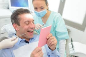 Patient,With,Mirror,Gap,After,Tooth,Extraction
