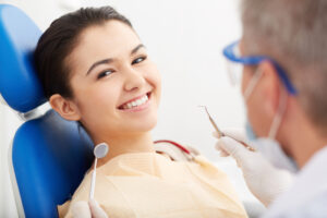 Woman happy and showing off her teeth after getting a dental bonding treatment done to repair her damaged teeth.